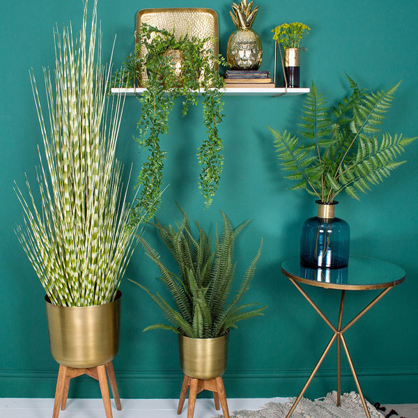 Midcentury-style brass planters at Audenza